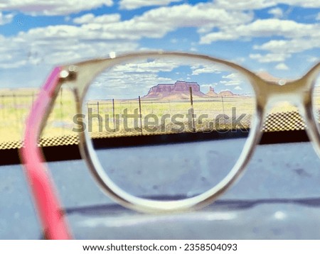 Hill view through a glass. Focus a hill tilla hummock with a glass.clear blue sky with white cloud.photography idea. A photo with a eyeglass.