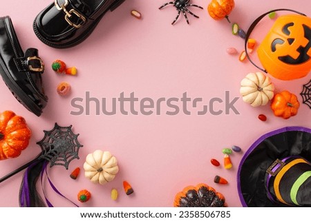 Bewitching Halloween witch attire for little girl. Top view of shoes, hat, enchanted wand, festive items, candy corn in basket, pumpkins, spooky spider, web on soft pink backdrop, frame for text or ad Royalty-Free Stock Photo #2358506785