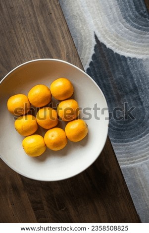 Clean modern interior design elements with 9 oranges in bowl