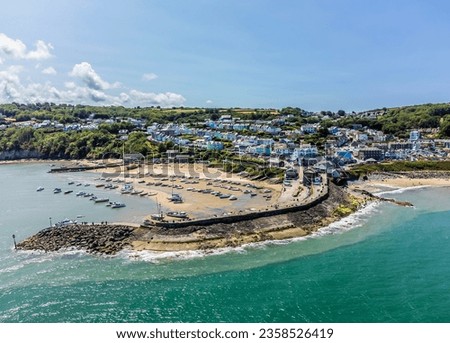 An aerial view from Cardigan Bay towards the harbour and the town at New Quay, Wales in summertime Royalty-Free Stock Photo #2358526419