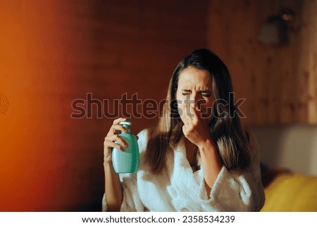 
Woman Allergic from the Perfume of her Body Lotion. Girl testing cosmetic product unsafe to use with an odd smell
 Royalty-Free Stock Photo #2358534239