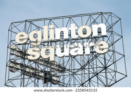 eglinton square shopping centre mall sign writing caption text mounted on black assembled metal decorative wires