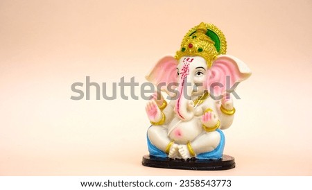 Hindu God Ganesha sclupture over pink background. Celebrate Lord Ganesha festival, Ganesh chaturthi