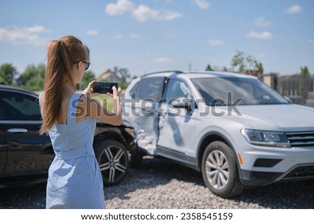 Stressed driver taking picture on sellphone camera of smashed vehicle calling for emergency service help after car accident. Road safety and insurance concept