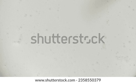 A top view picture of white froth milk with milk frother at home for background