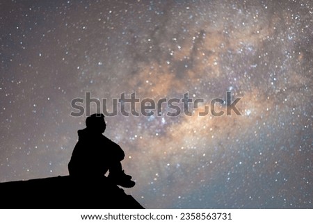 man sitting with silhouette view isolated the stars