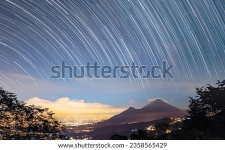 night sky over mountain isolated trails of the stars