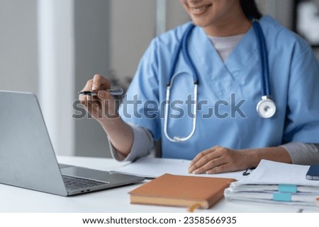 Female doctor or physiotherapist talking to patient online via video call on laptop computer and mobile phone. medical meeting, treatment, treatment