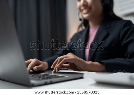 Asia call center with headset and microphone working on laptop Female entrepreneurs serving customers, business information, inquiries Support call center representatives help customers.