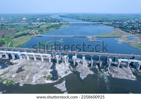 Aerial footage of the River Bhima and surrounding landscape including bridges at Daund India. Royalty-Free Stock Photo #2358600925