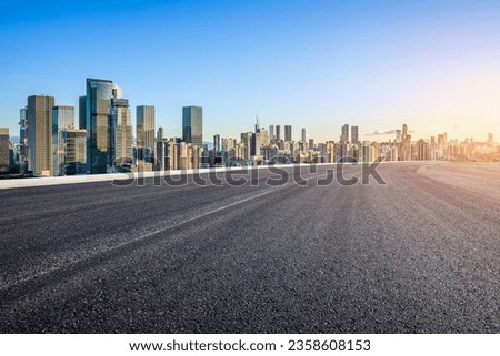 Asphalt highway road and city skyline background