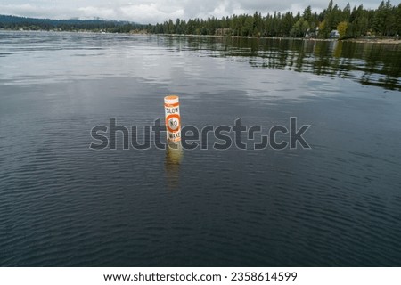 boy in the water indicating to slow down and not leave a wake