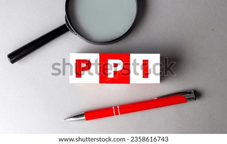 PPI word on a wooden cubes with pen and magnifier