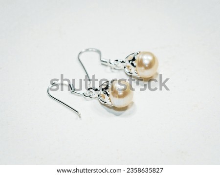 Pearl earrings display on white background
