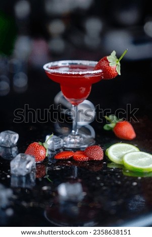 Fresh homemade refreshing strawberry cocktail margarita in glasses on the table