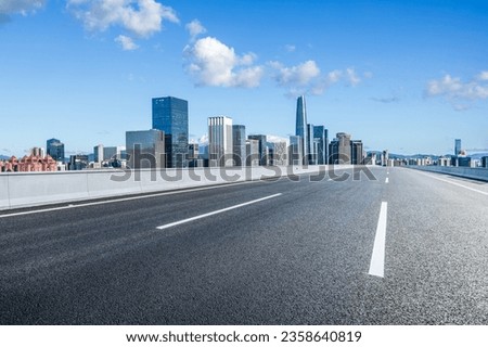 Asphalt highway road and city skyline with modern buildings