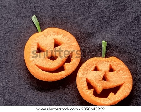 Two pumpkins on a black background.