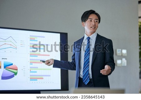 Japanese businessman wearing a suit giving a presentation