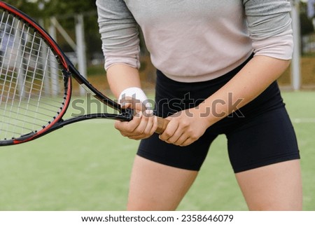 Female Tennis Player Holding the Racquet During Match, Ready for Receive Ball Strike.