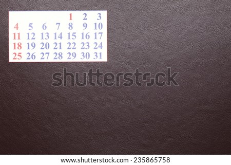 Small calendar put on brown color leather organizer pad represent the new year and business.  