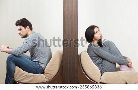 Conflict between man and woman sitting on either side of a wall Royalty-Free Stock Photo #235865836