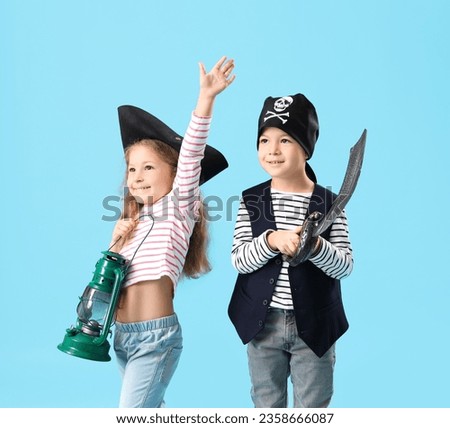 Cute little pirates with lantern and sword on blue background