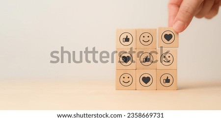Social media engagement, Digital marketing concept. Placing the wooden cube blocks with emoticons, creating social media platforms to build relationships and drive sales. Sharing customer experiences.