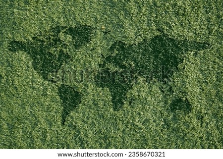 artificial grass or carpet with synthetic grass and with a world map silhouette. photos for the concept of go green and save the earth Royalty-Free Stock Photo #2358670321