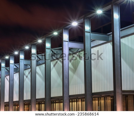 Side of building with repeating pattern and lights