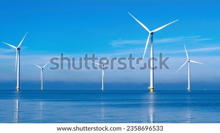 offshore windmill park with clouds and a blue sky, windmill park in the ocean aerial view with wind turbine Flevoland Netherlands Ijsselmeer. Green Energy in the Netherlands Royalty-Free Stock Photo #2358696533