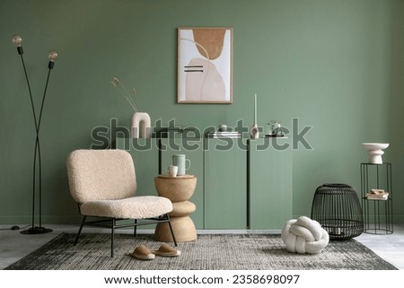 Stylish living room interior design with mock up poster frame, frotte armchair, wooden commode, side table, plants and creative home accessories. Sage green wall. Home staging. Template. Copy space. Royalty-Free Stock Photo #2358698097