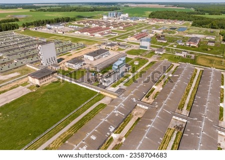 aerial panoramic view over livestock farm and agro-industrial complex with silos and rows of barns, pigsties, chicken coops	
 Royalty-Free Stock Photo #2358704683