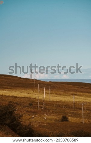 A series of crooked Powerlines heading over the horizon. Royalty-Free Stock Photo #2358708589