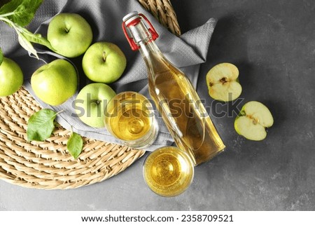 Flat lay composition with delicious apple cider on gray table