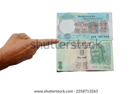 Hand finger sign Indian currency 5 rupees different bank notes on white background. 