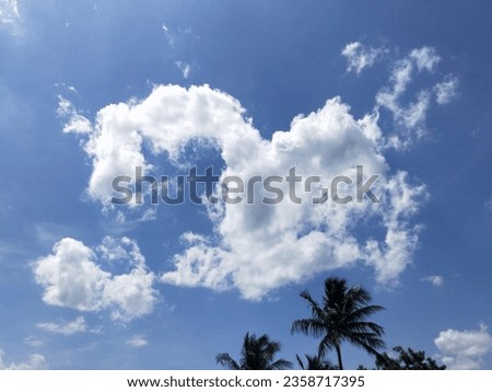 bird shaped cumulative clouds visible in the deep blue sky