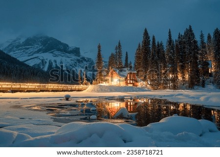 Beautiful view of Emerald Lake with snow covered and wooden lodge glowing in rocky mountains and pine forest on winter at Yoho national park, British Columbia, Canada Royalty-Free Stock Photo #2358718721