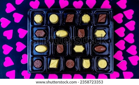 delicious chocolate surrounded by a pink heart on a black background