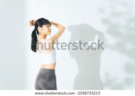 Body care concept of young woman. Sports gym. Stretching. Royalty-Free Stock Photo #2358735213