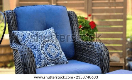 The empty blue armchair with a pillow.
