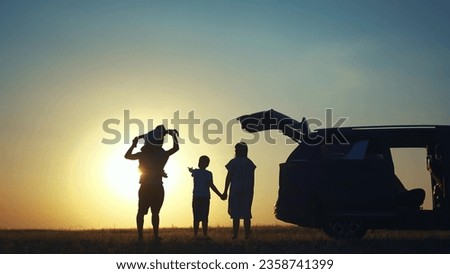 family traveling by car. family watching sunset silhouette next to the car in the park. happy family kid dream concept. people in the park. lifestyle family car camping resting in nature Royalty-Free Stock Photo #2358741399