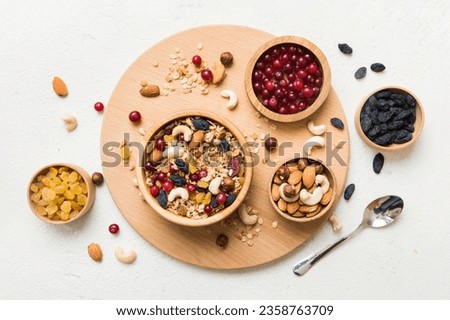 Cooking a wholesome breakfast. Granola with Various dried fruits and nuts in a bowl. The concept of a healthy dessert. Flat lay, top view with copy space.
