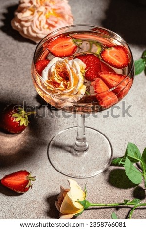 pink wine with strawberries in glasses, vertical image. top view. place for text.
