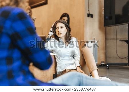 Beautiful, brunette girl trying to figure it out what her male colleague is talking about.
