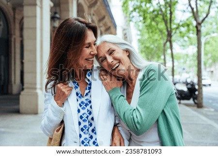 Beautiful senior women bonding outdoors in the city - Attractive cheerful mature female friends having fun, shopping and bonding, concepts about elderly lifestyle Royalty-Free Stock Photo #2358781093