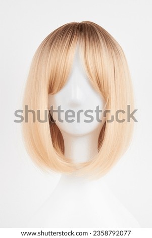 Natural looking blonde fair wig on white mannequin head. Short hair cut on the plastic wig holder isolated on white background, front view
 Royalty-Free Stock Photo #2358792077