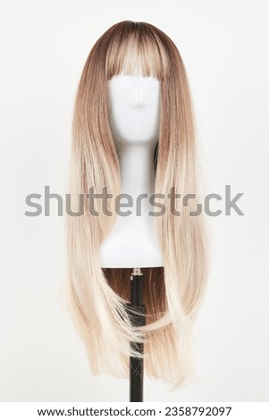 Natural looking blonde wig on white mannequin head. Long hair on the plastic wig holder isolated on white background, front view
 Royalty-Free Stock Photo #2358792097