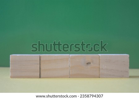 Empty wooden cubes on colored background