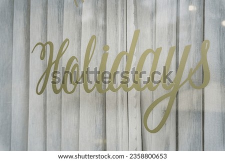 Window sign Holidays inscription in a shop window