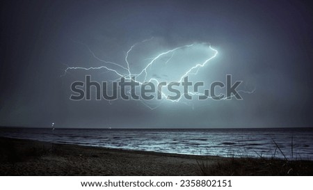 The beautiful scene of lightning in the gray sky over the sea